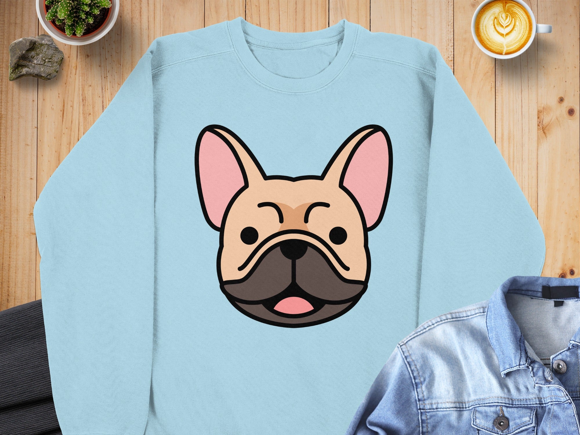 Light blue sweatshirt with a cartoon French bulldog face graphic.