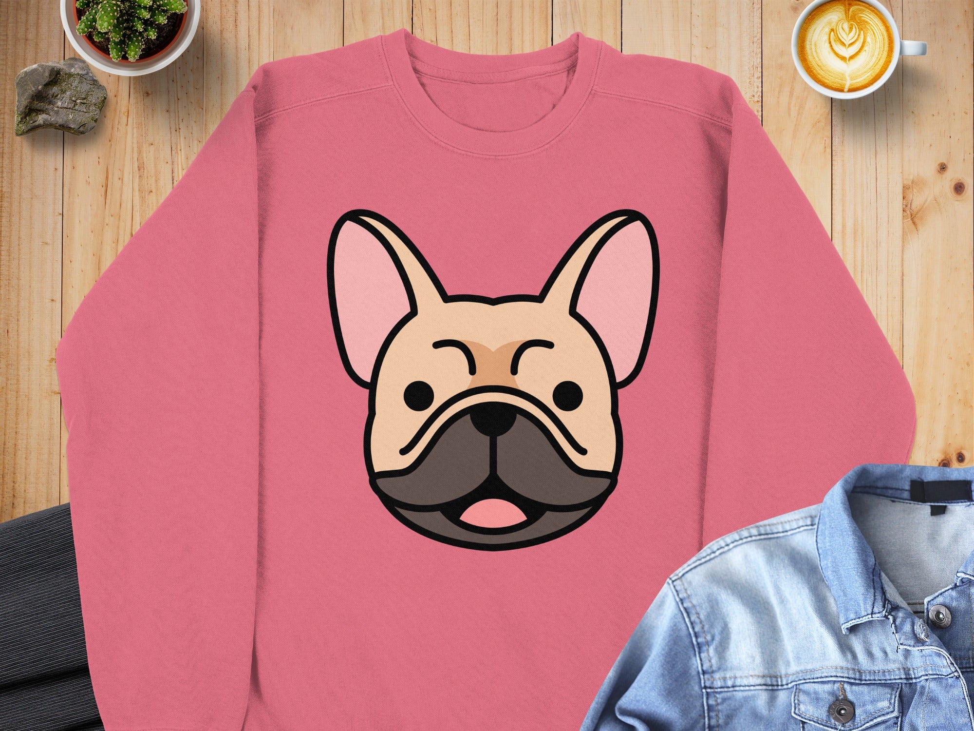 Pink sweatshirt with a cartoon French Bulldog face graphic.