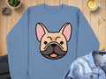 Blue sweatshirt with a cartoon French bulldog graphic.