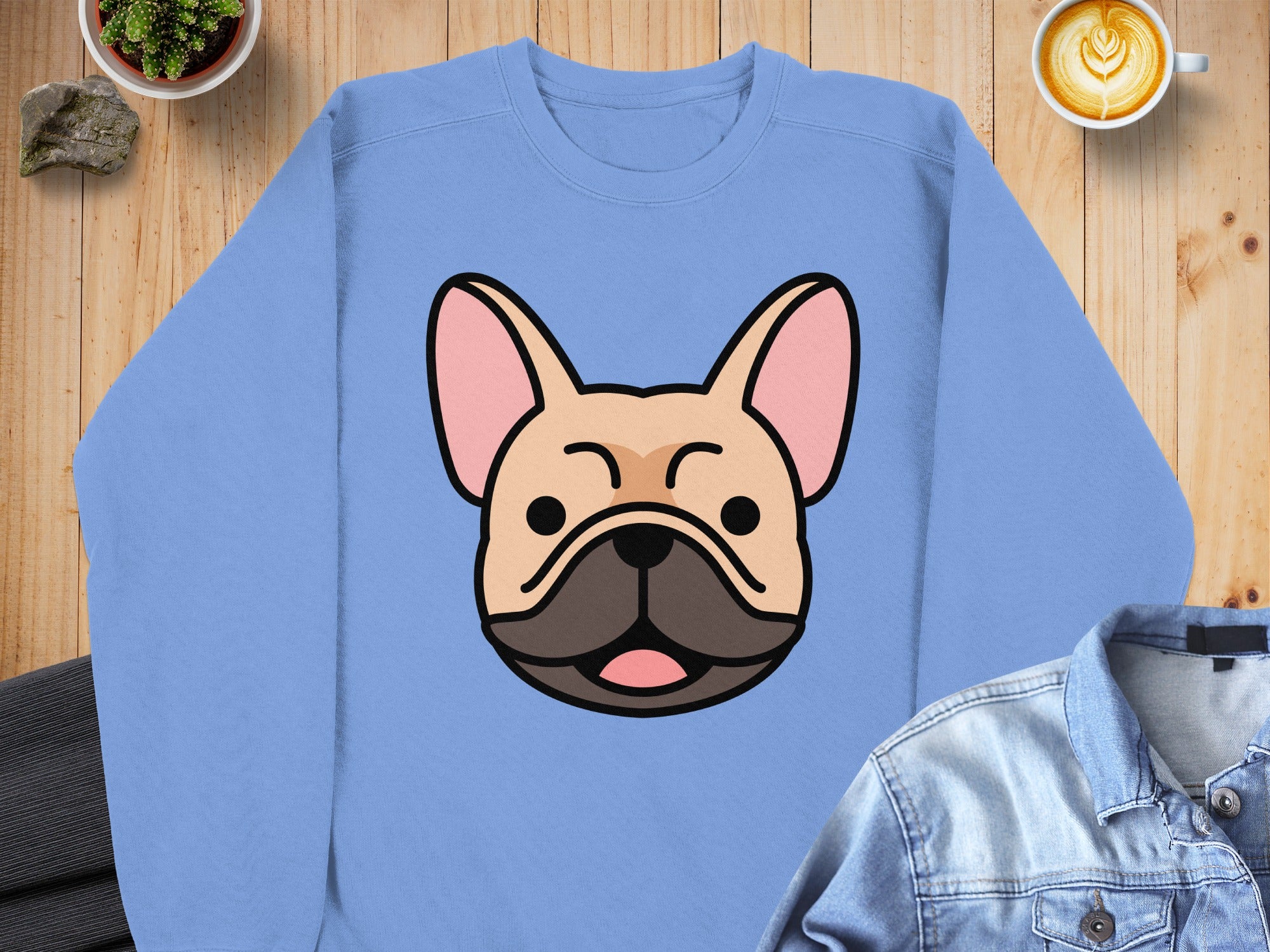 Light blue sweatshirt featuring a cartoon French bulldog face graphic.